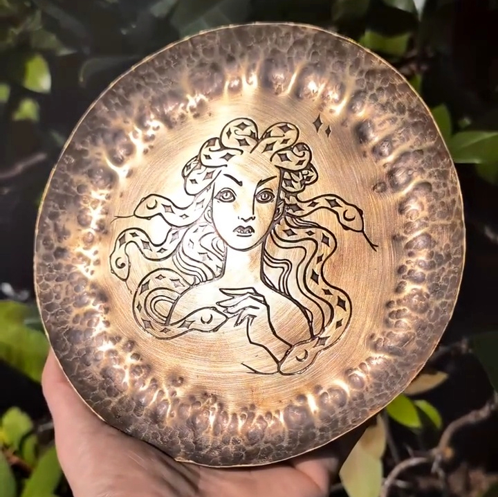 Hand-hammered copper dish etched with Medusa and her snakes by BorboroForge