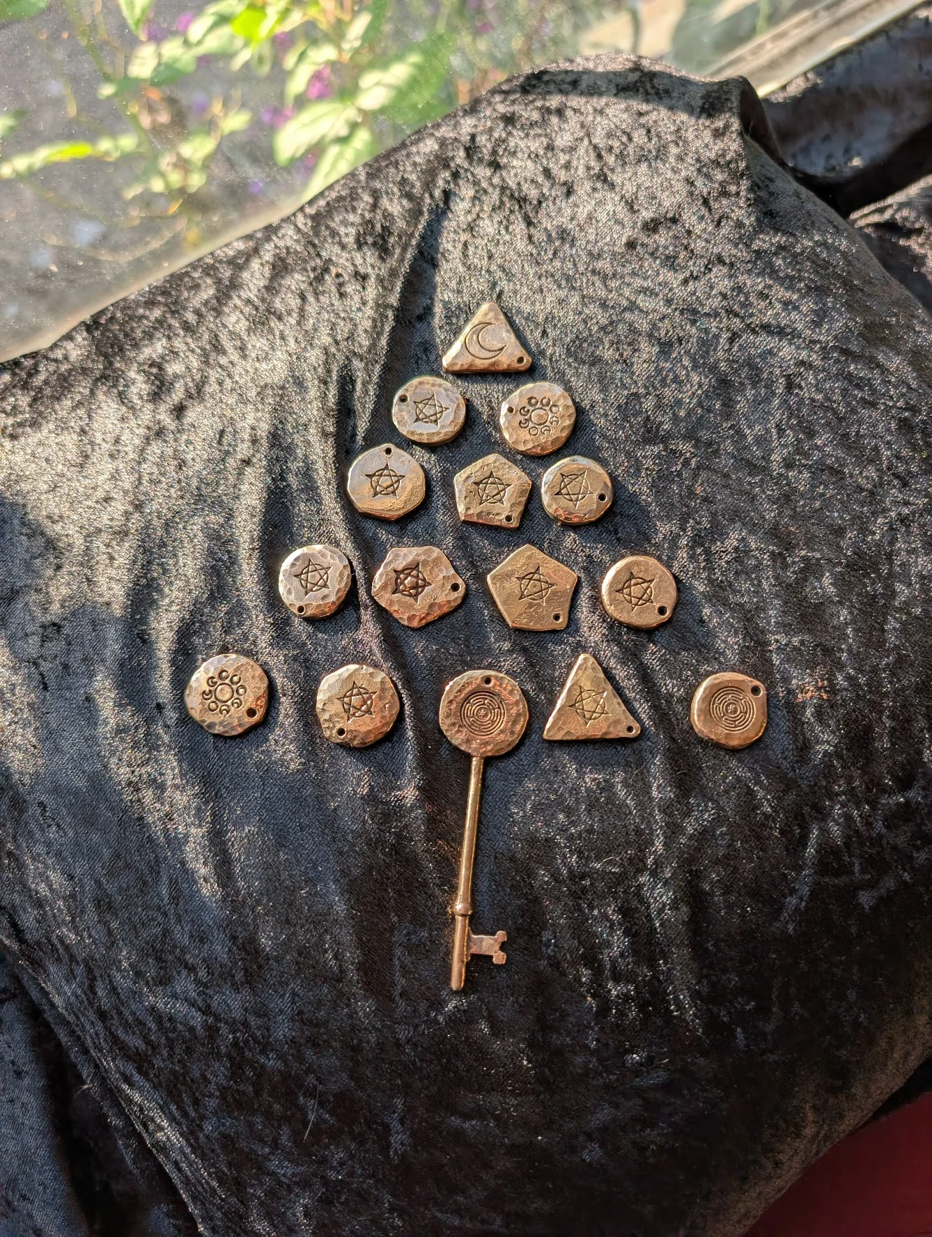 Cast bronze witchcraft charms with occult symbols on black velvet by BorboroForge